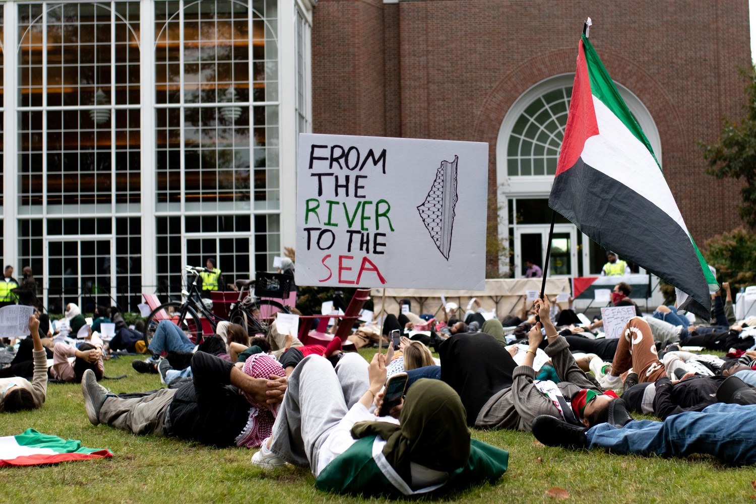 Demonstrators stage a die-in in front of Klarman Hall at HBS on Wednesday to demand an end to violence in Gaza.