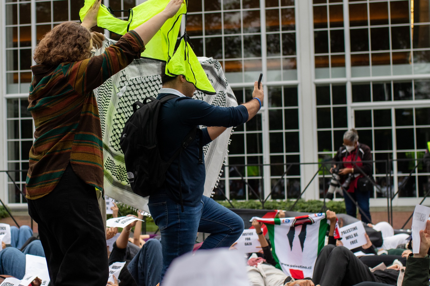 Protesters at an Oct. 18 pro-Palestine "die-in" demonstration attempted to block the camera of a Harvard Business School student who was filming protesters' faces.