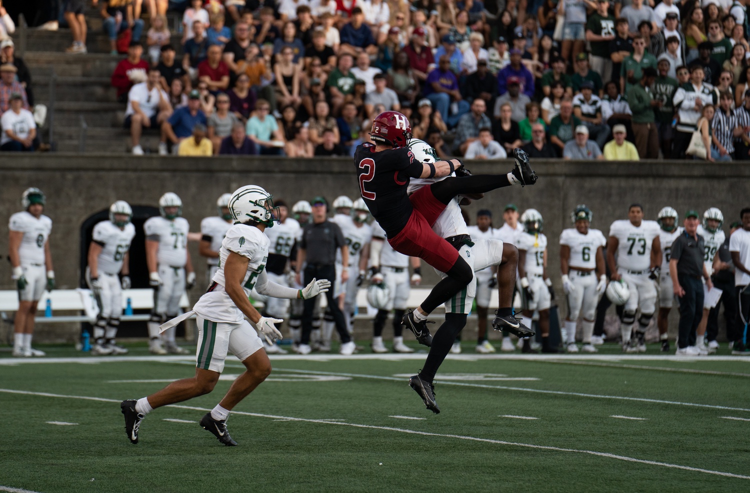 Sophomore wide receiver Cooper Barkate lunges upward for a pass in the Crimson's Oct. 28 game against Darmouth. Harvard pulled out a 17-9 win over the Big Green.