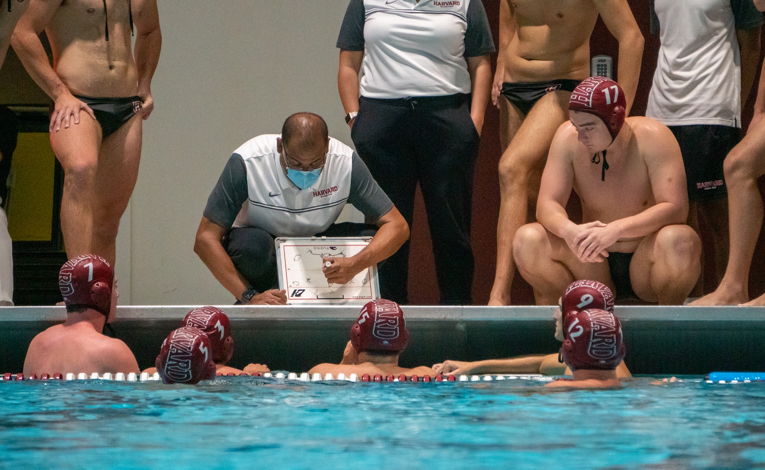 Harvard water polo head coach Ted Minnis draws up a play for his team on September 5, 2021 against Wagner at home at Blodgett Pool.