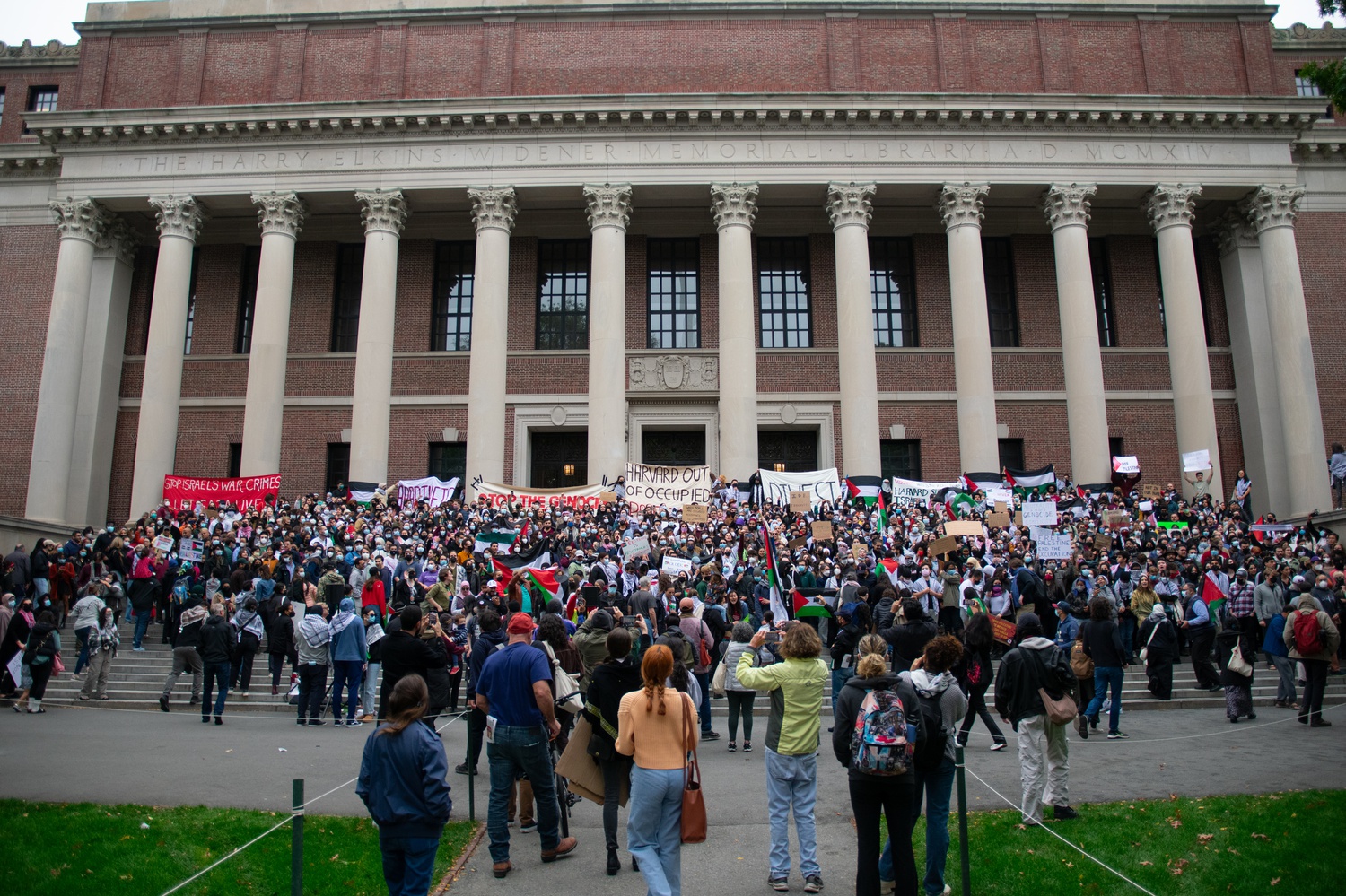Rally attendees posed for a photo on the steps of Widener Library.